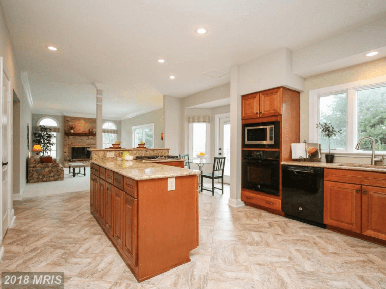 Large kitchen with wood cabinets and large appliances.