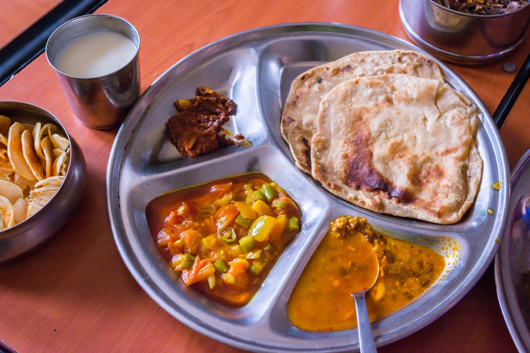 A plate of various Indian dishes.